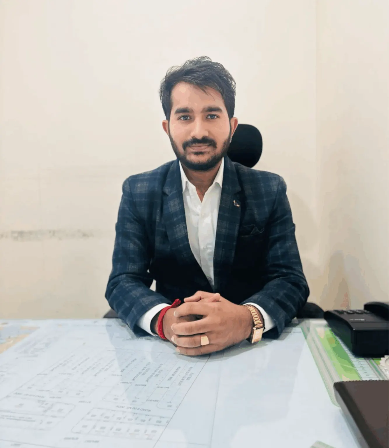 Mr. Babulal Kumawat, founder of Real Unique World, at his desk in Jaipur